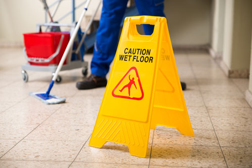 A caution sign depicting a wet floor
