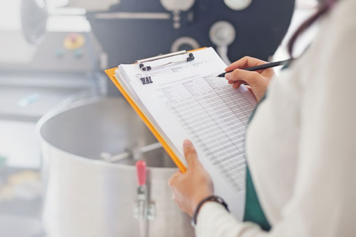 Someone filling out a form on a clipboard