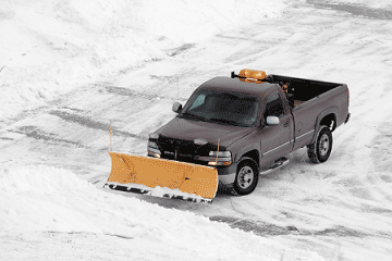 Truck plowing snow mobile view