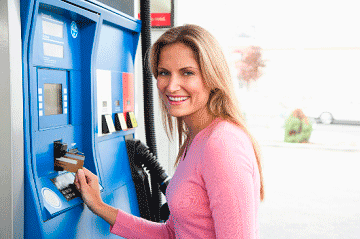 Someone paying for gas at a pump using a credit card