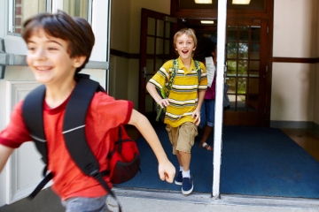 Two boys running in school
