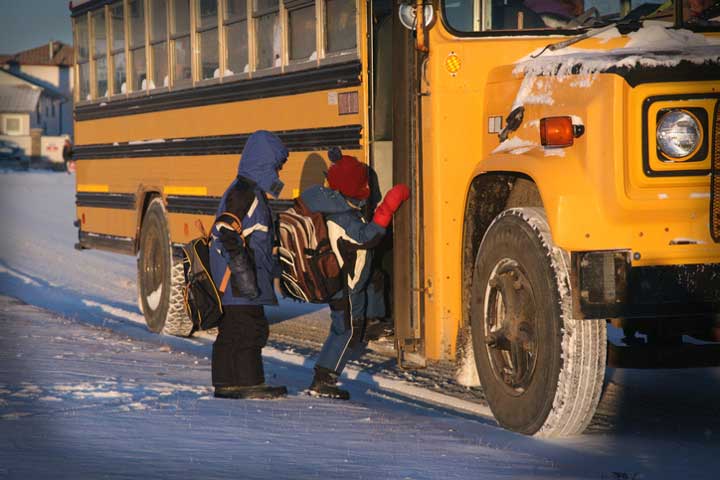 Kids boarding winter school bus mobile view