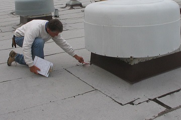 Tradesman inspecting a roof