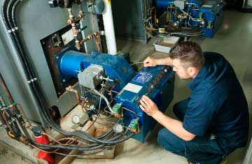 Contractor working on a boiler machine