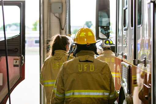 Firefighters beside a fire truck